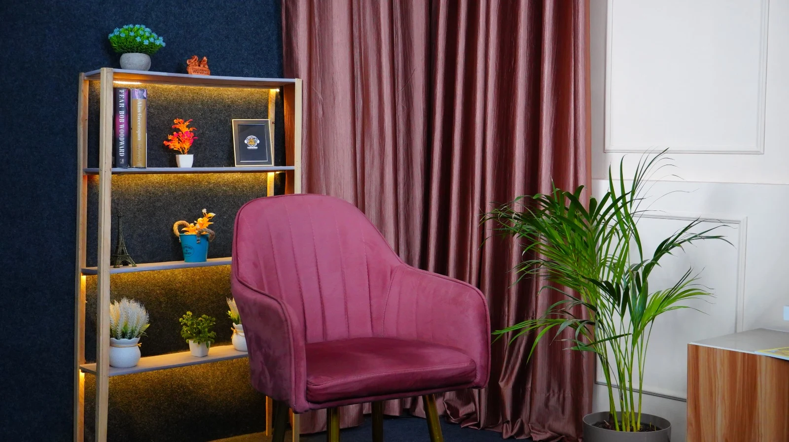 Mic and Minds studio bookshelf with warm golden LED accent lighting