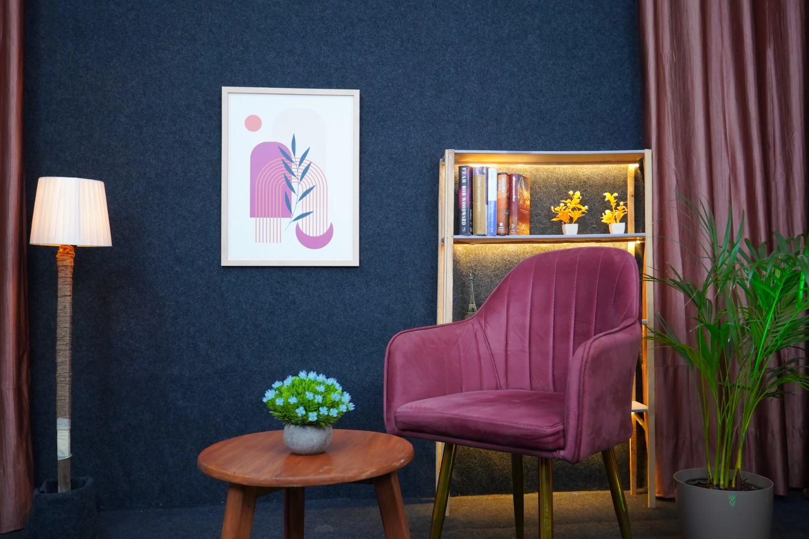 Mic and Minds studio single chair setup with wall art and bookshelf accent lighting